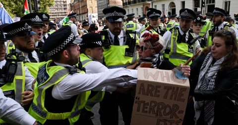 Protesters clash with police cordon after thousands march through central London